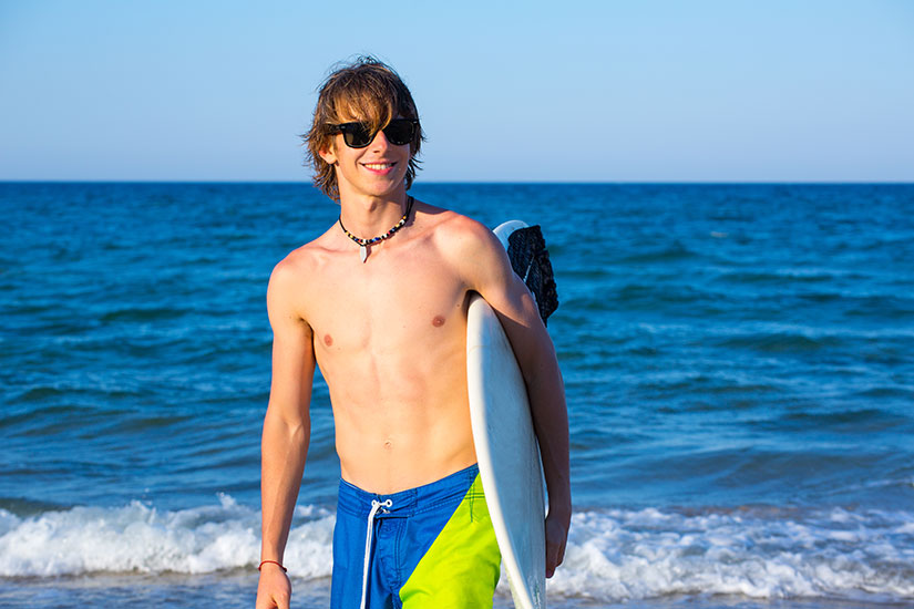 teen surfer wearing sunglasses
